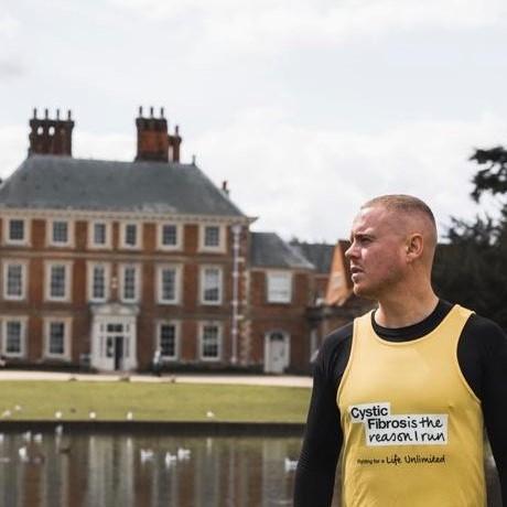 Young white man posing in bright yellow running vest