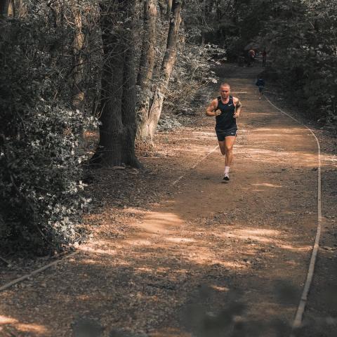 Man running along a gravel path