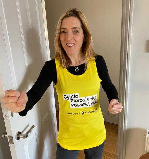 Sarah wearing a CF Trust yellow running vest for Running Festival