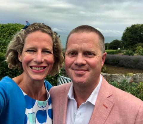 Tim and with wife Katie pictured standing outside by a river