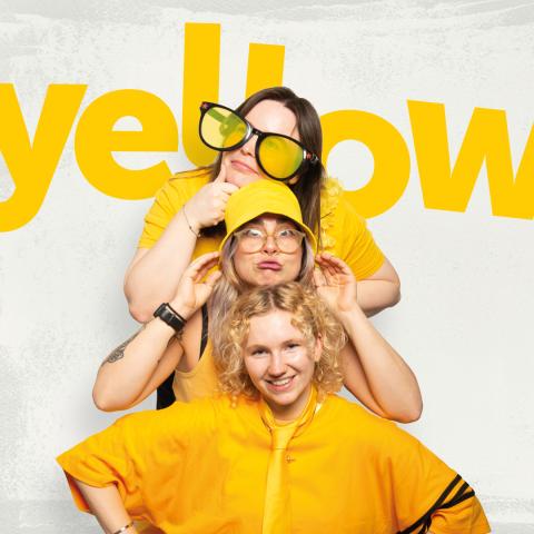 Three women wearing yellow to celebrate Wear Yellow Day