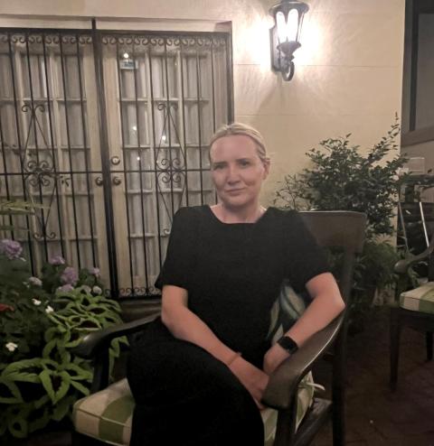 Laura sits on a table outside