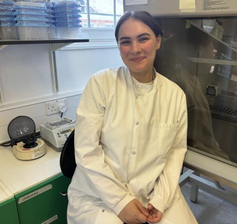 Women smiling at the camera in the lab
