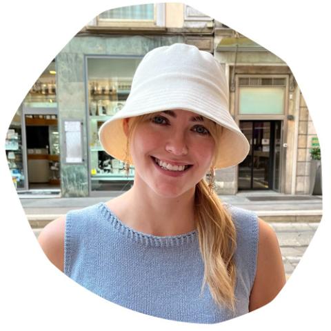 Bethinn, a young woman with CF, wearing a white bucket hat and a blue top