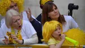 Two women and a child cheering on runners for the Cystic Fibrosis Trust at the London Marathon