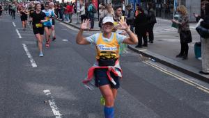 A lady running with Cystic Fibrosis Trust top on 