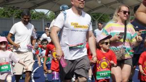 a father and daughter getting ready to run a race